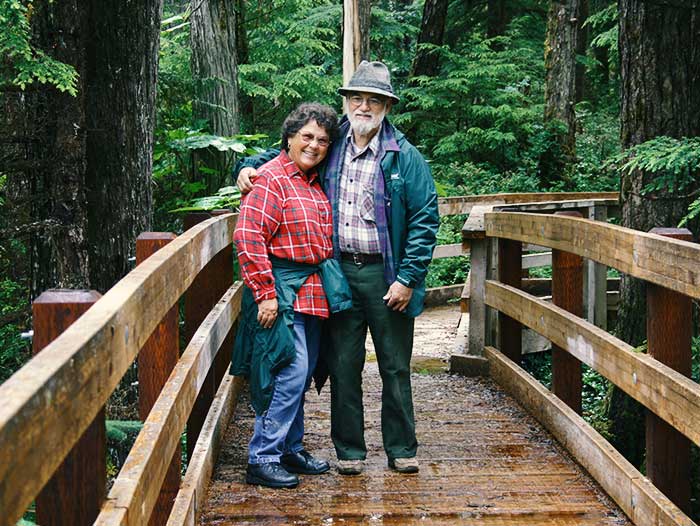 Alaska hiking trails on Prince of Wales Island. Man and woman on boardwalk trail in Tongass National Forest