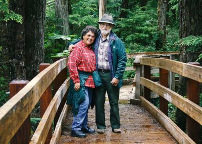 Alaska hiking trails on Prince of Wales Island. Man and woman on boardwalk trail in Tongass National Forest