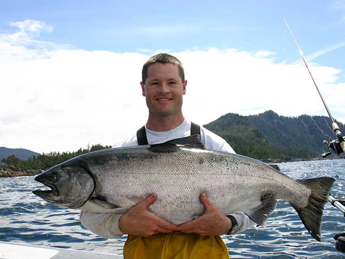King Salmon fishing on Prince of Wales Island. Adventure Alaska Southeast fishing charters. Man holding giant King Salmon