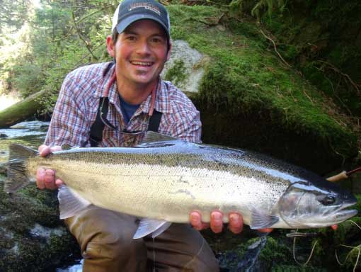 Fly-fishing on Prince of Wales Island Alaska. Steelhead trout with fly in mouth. Adventure Alaska Southeast offers fully-guided stream fishing.