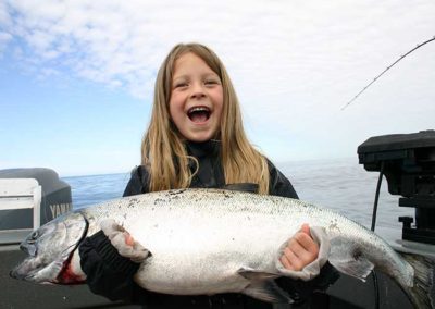 King Salmon fishing on Prince of Wales Island. Adventure Alaska Southeast fishing charters. Little girl holding giant King Salmon