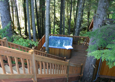 Adventure Alaska Southeast, fish Alaska, relax in nature. Hot tub situated in woods on a deck in Thorne Bay, Alaska