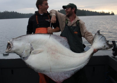 Halibut fishing at Adventure Alaska Southeast. Two men with halibut in Thorne Bay, Alaska