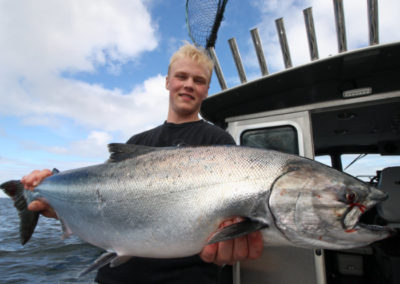 King Salmon fishing on Prince of Wales Island. Adventure Alaska Southeast fishing charters. Man holding giant King Salmon